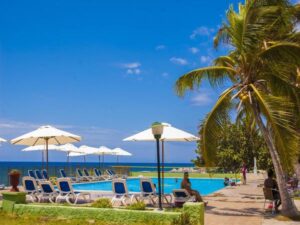 People are chilling near the pool in Hotel Costa Morena